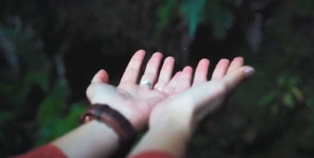 Woman washing hands in an established toilet area, essential for safe camping.