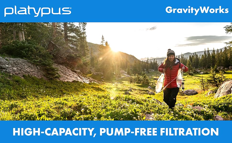 Woman hiking in a mountain valley in autumn with the Platypus GravityWorks water filter. "High-capacity, pump-free filtration."