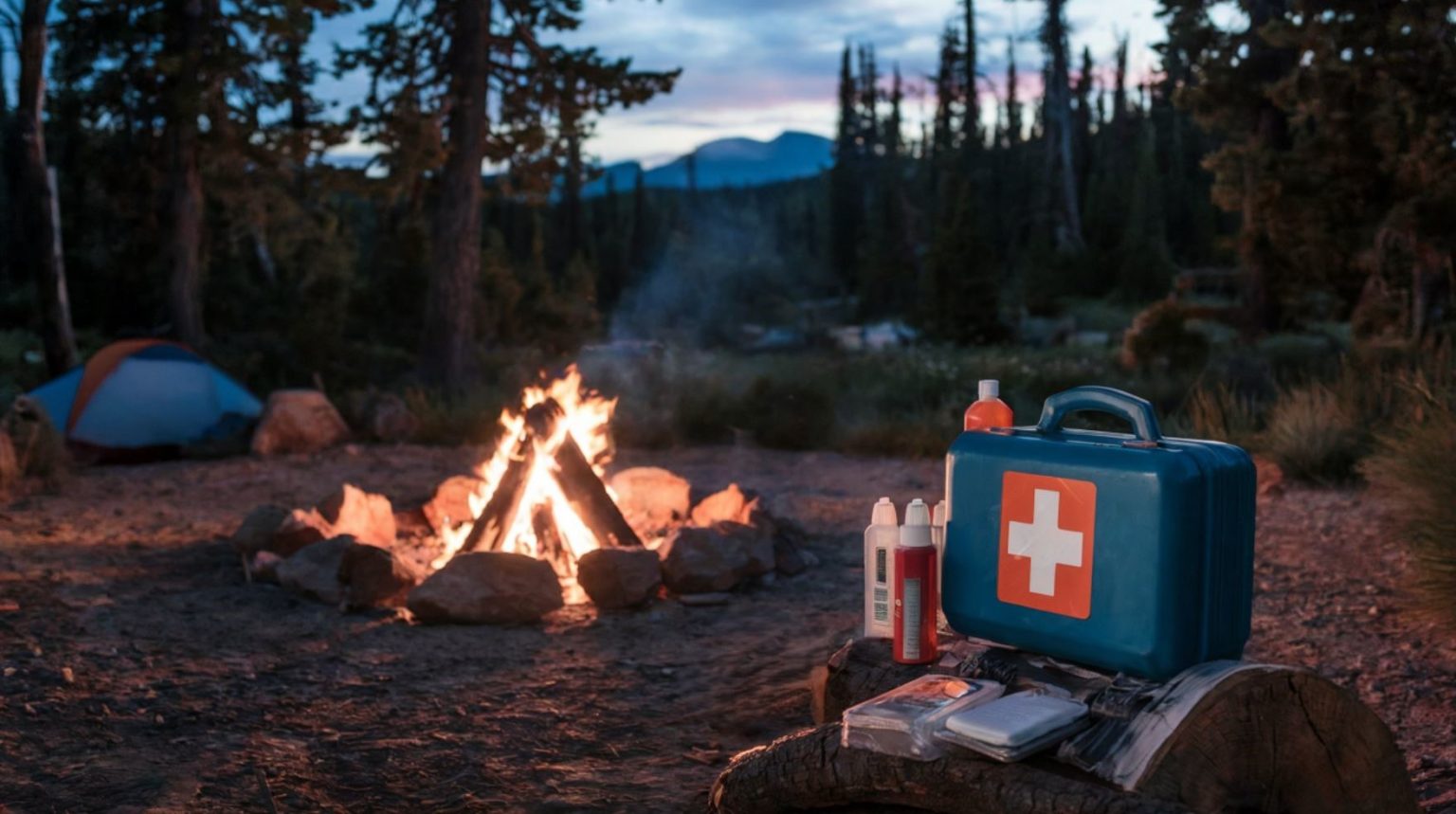 Serene camping scene at night by a campfire with first aid kit and supplies displayed on a rustic log.