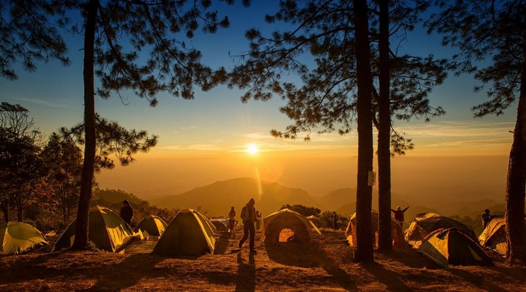 A camping group at sunrise beginning their day confident with their camping skills.