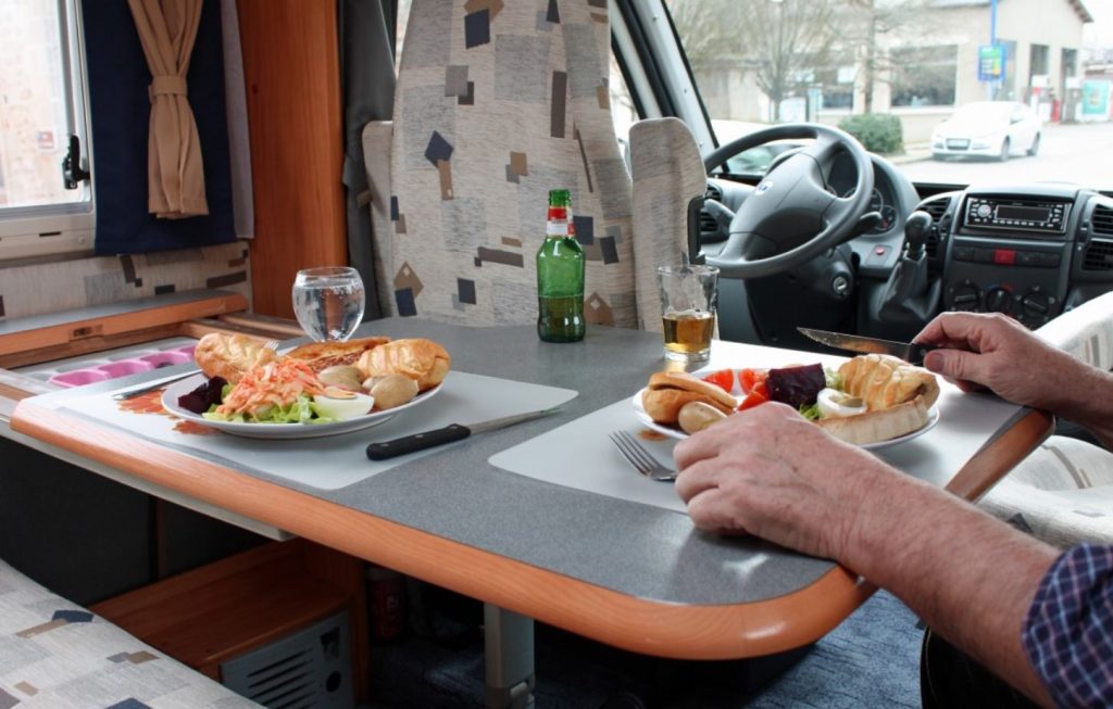 Two plates served on an RV dining table, making the most of a well-stocked RV kitchen.