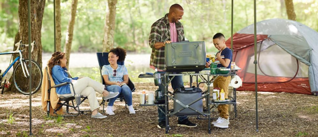 A family using a portable full cook station from GCI Outdoor.