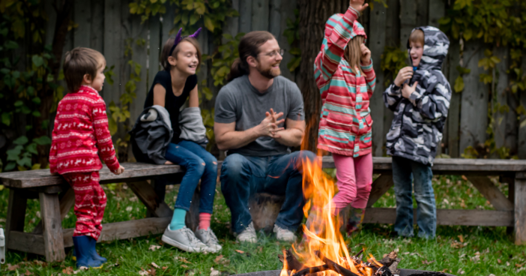 Father telling an interactive story with his four kids to promote fun and creative storytelling.