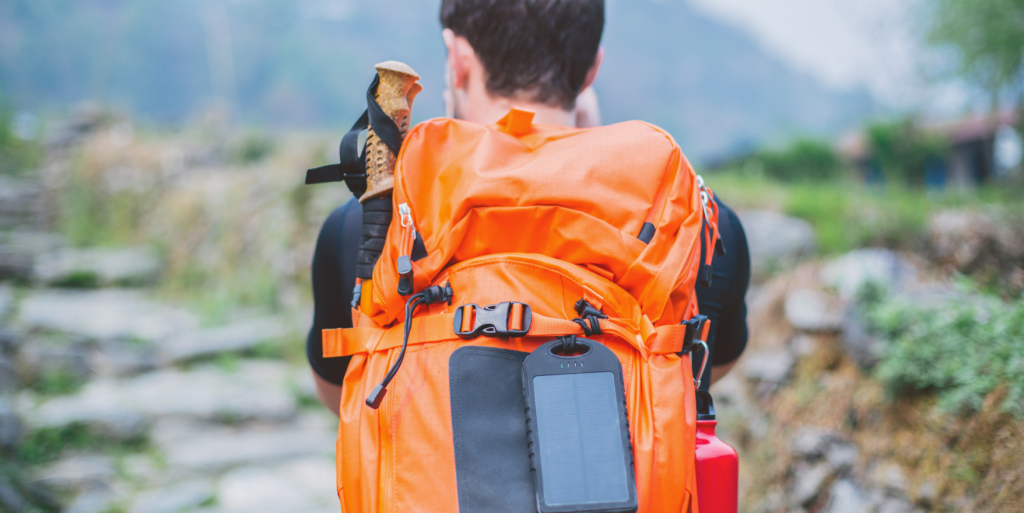 A man hiking with a waterproof solar backpack. It's essential to seek out rugged solar camping gear when you are off-grid in the wilderness.