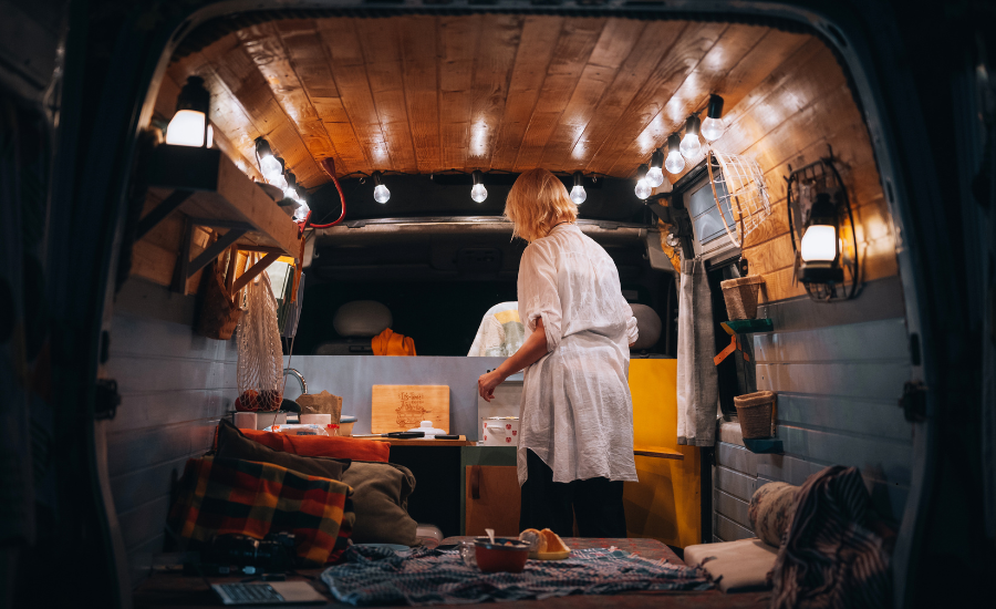 A woman in a van with a lot of lighting and curtains designed for privacy and security.