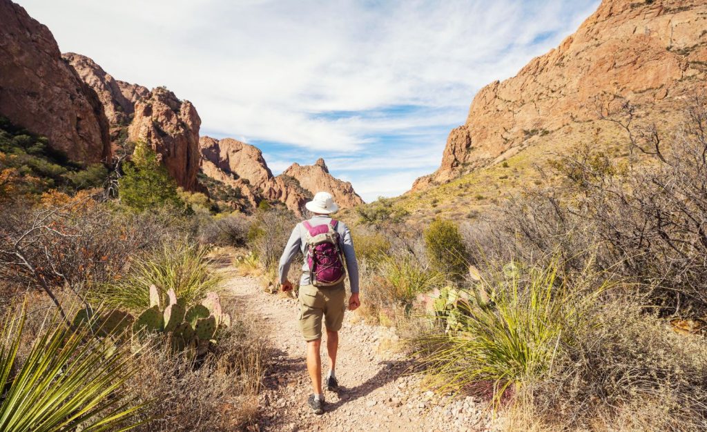 A man backpacking through Big Bend National Park, Texas, one of the premier destinations for escaping the cold to camp in winter.