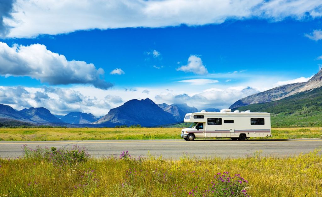 An RV traveling to Glacier National Park, Montana on a beautiful sunny day.