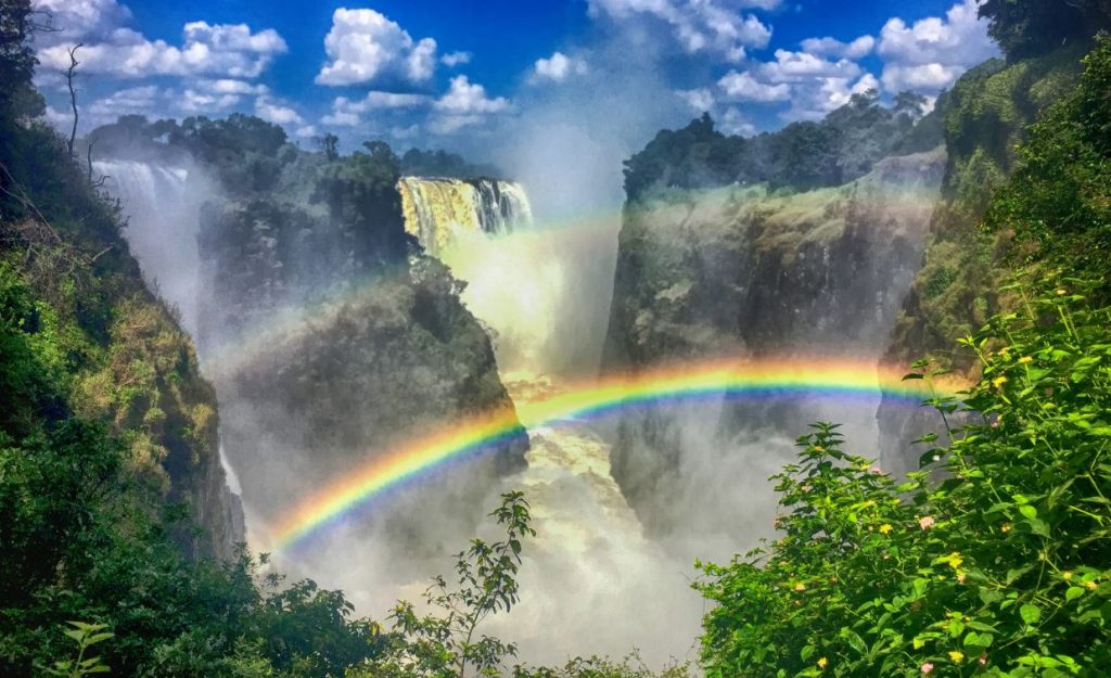 A stunning rainbow is seen over the chasm that frames Victoria Falls in Africa.