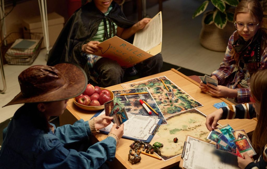 A group of kids playing a travel card game indoors on a rainy day.